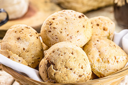 bowl full of traditional Brazilian cheese bread or cheese biscuit, served crispy and hot, with coffeeの写真素材