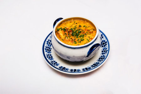 hot cassava broth, traditional homemade soup from Minas Gerais, Brazil, served hot with parsley and...