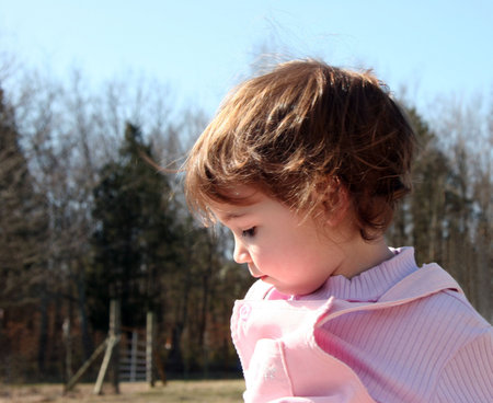 Beautiful  girl on a farm and looking down.