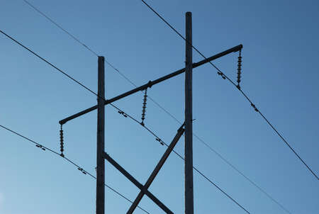 Powerlines silhouetted against the blue autumn sky.の写真素材