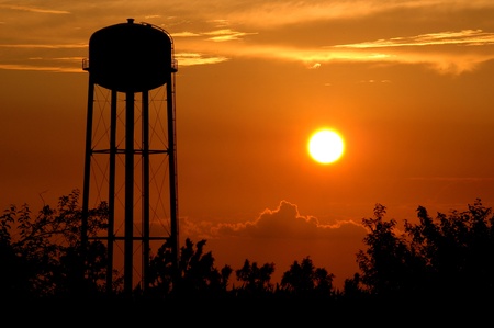Kansas Sunset. Water tower silhouetted in the sunset east of Seneca, Kansas.の写真素材