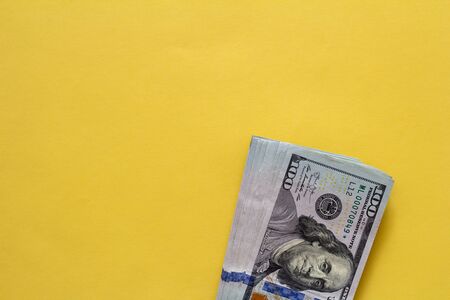Flat closeup of dollars on yellow background. Investment profit income. Success concept. Finance investment concept. Flat design element. Dollar sign. Hundred dollar bill.の写真素材