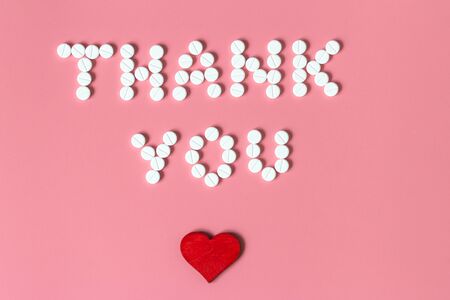 Internationals nurses day, week concept, Text Thank you by tablets and red heart on pink background.の写真素材