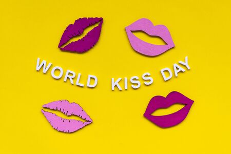 Words world kiss day or international kissing day. 6th July. Greeting card. Red and pink lips on yellow backgroundの写真素材