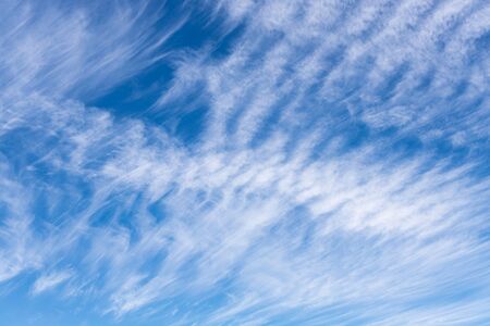 Blue sky with feather white cloud. Pattern of cloud on sunny dayの写真素材