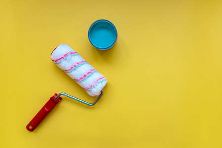 Paint roller for painting and priming new on yellow Backgroundの写真素材
