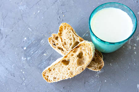 Bread and milk in blue glass. top viewの写真素材
