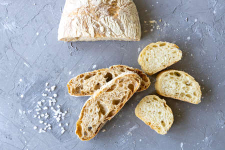 Fresh sliced bread with salt flat lay. Ciabattaの写真素材