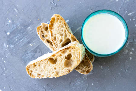 Bread and milk in blue glass. top viewの写真素材