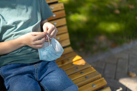 Medicine mask in kids hands close up. Outdoor.の写真素材