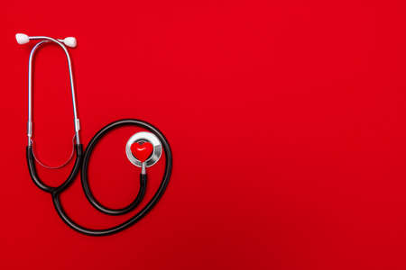 Medical Christmas banner with stethoscope on red background.の写真素材