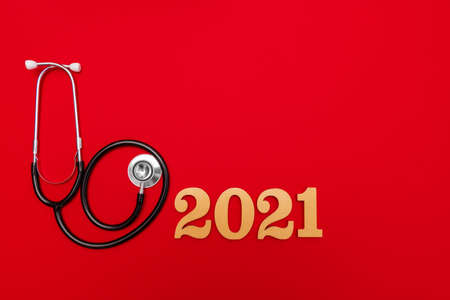 Stethoscope 2021 gold number on red background. Happy New Yearの写真素材