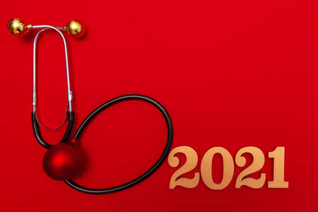 Stethoscope 2021 gold number on red background. Happy New Yearの写真素材