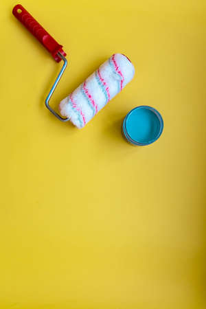 Paint roller for painting and priming new on yellow Backgroundの写真素材