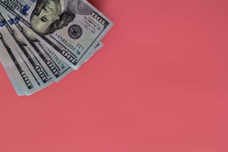 Money on pink background. closeup of dollars copy space. Investment profit income. Success concept. Finance investment concept. Dollar sign. Hundred dollar bill.の写真素材