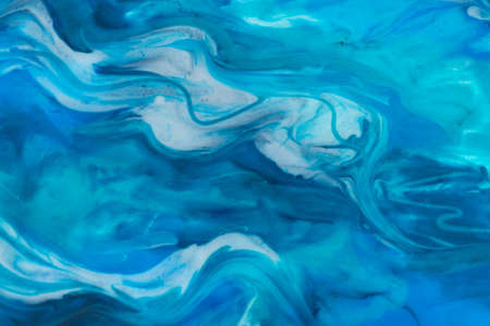 Epoxy resin art. Texture of blue and white paint. Fluid art, kintsugi. Close upの写真素材