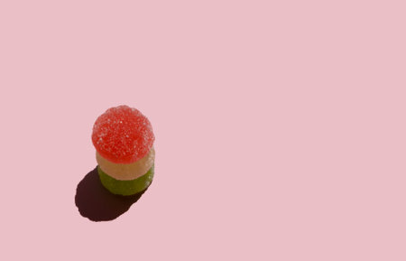 Jelly candies on pastel pink background. Color minimalism. Minimal sweets backdrop. Sunny day shadow.の写真素材
