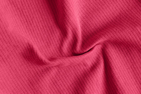 Viva magenta color of the year 2023, ribbed texture of cloth. Fabric textile pattern.の写真素材
