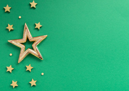 Golden stars on green. Christmas, new year 2023 concept. Top view of different christmas stars.Flat lay, top view.の写真素材