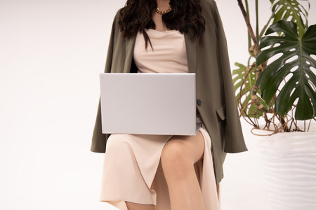 Business lady in elegant dress working on laptop against white background. Technology and internet communication. Businesswoman in dress work online on laptop.Copy space.の写真素材