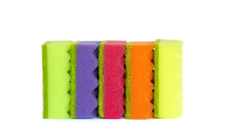 Stack of many multi-colored dish wash sponges isolated on white background. Household cleaning scrub pad.の写真素材