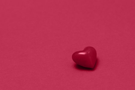 Valentines day red heart on same color background. Monochromatic vivid color. Valentine's day concept. Close up, copy spaceの写真素材