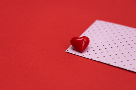 Valentines day red heart on same color background. Monochromatic vivid color. Valentine's day concept. Close up, copy spaceの写真素材