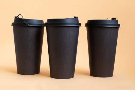 Set of three takeaway black coffee cup on neutral background. Mock -up, nobody, front viewの写真素材