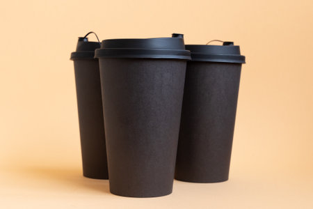 Set of three takeaway black coffee cup on neutral background. Mock -up, nobody, front viewの写真素材