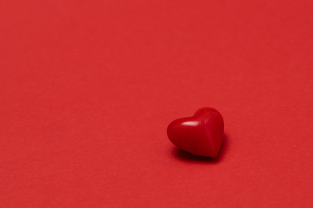 Valentines day red heart on same color background. Monochromatic vivid color. Valentine's day concept. Close up, copy spaceの写真素材