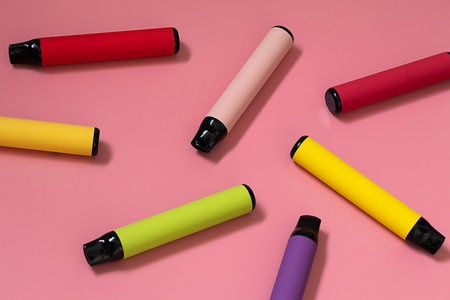 Layout of colorful disposable vapor stick on a light background. Concept of modern e-smoking, vaping and nicotine, electronic cigarettesの写真素材