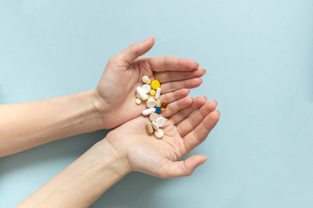 Hands of woman holding pills. Seasonal affective disorder conceptの写真素材