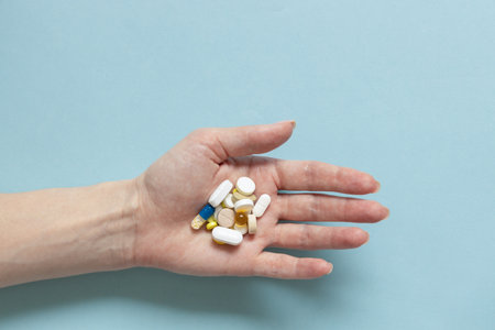 Hands of woman holding pills. Seasonal affective disorder conceptの写真素材