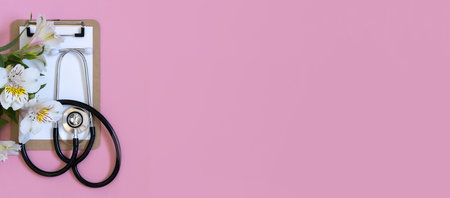 Horizontal banner, medics day, doctors day. Medical equipment above pastel pink background. Space for textの写真素材