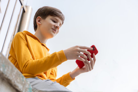 Portrait of smiling teen boy using smartpone. Blogging, surfing, video call. Generation z, mobile...