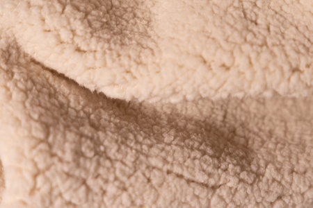 Top view of white soft sheepskin textile plaid. Warm cozy texture backgroundの写真素材