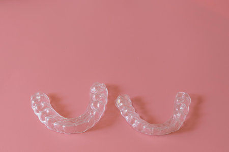 Transparent aligners, invisalign bracer smile isolated on pastel light pink backgroundの写真素材