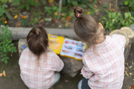 Back view of two children drawing outdoor. Outdoor activities, kids imaginationの写真素材