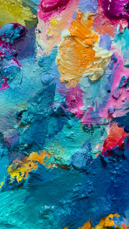 Background of bright oil-paint palette close-up pattern, blue, yellow, pink color textureの写真素材