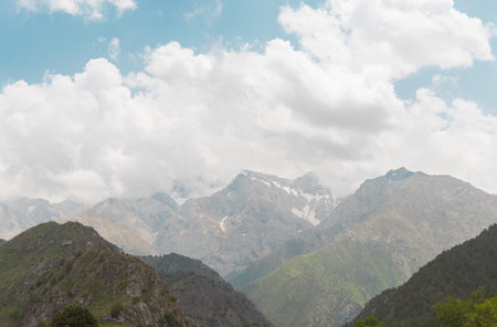 Mountain landscape with slightly snow-covered peaks in Sairam-Ugam National Park under clear sky....