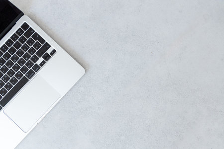 Minimal close up of laptop part on neutral gray background with copy space. Modern technology...