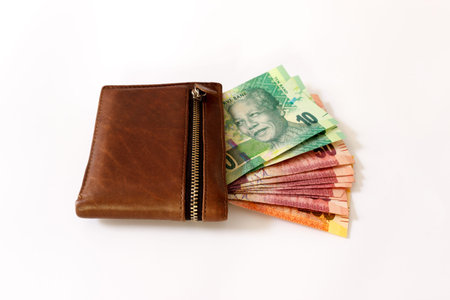 South African Rand in wallet on a white canvas