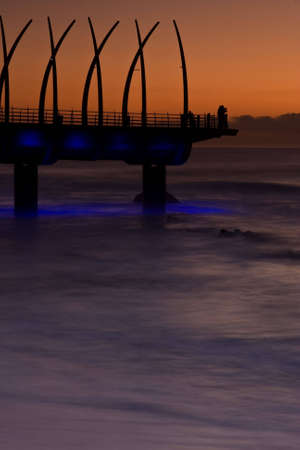 Umhlanga Pier at sunrise with lights onの写真素材