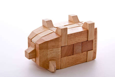 Wooden Pig Interlocking puzzle isolated on whiteの写真素材