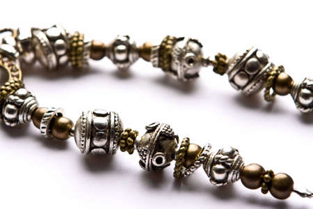 Silver designer costume juwelery in macro on white backgroundの写真素材