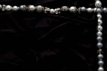 Silver designer costume jewelery on black velvet backgroundの写真素材