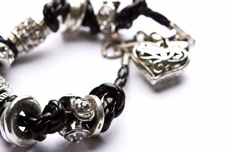 Silver designer costume jewelery in macro on white backgroundの写真素材