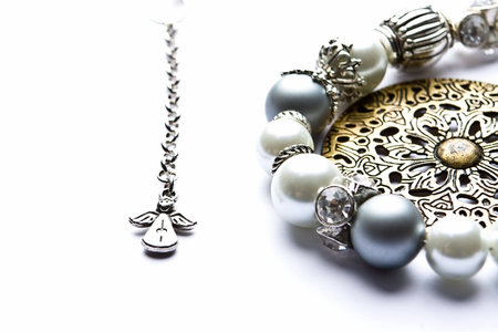 Silver designer costume jewelery in macro on white backgroundの写真素材