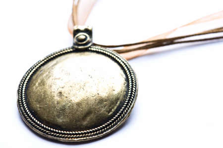 Brass designer costume jewelery in macro on white backgroundの写真素材