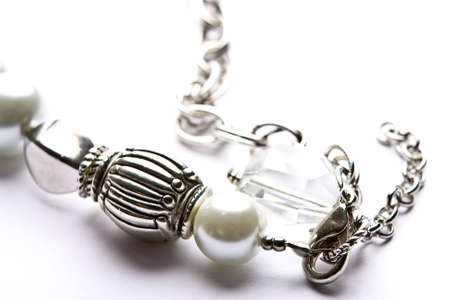 Silver designer costume jewelery in macro on white backgroundの写真素材